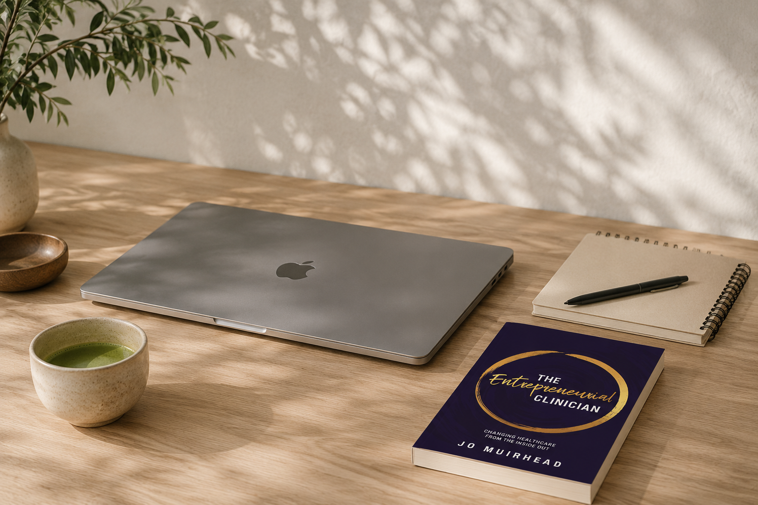 Laptop, notebook and matcha on a light wood desk